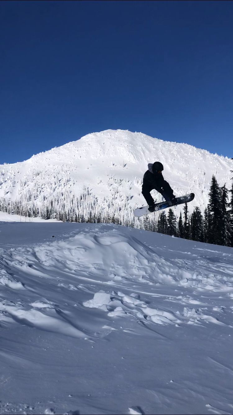 Snowboarder jumping in fresh Okanagan snow